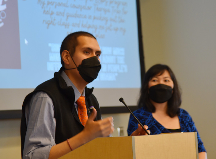 Diego Espinoza speaks to students at a podium.