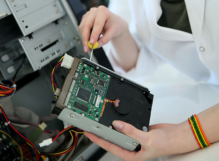 Hands working on a circuit board.