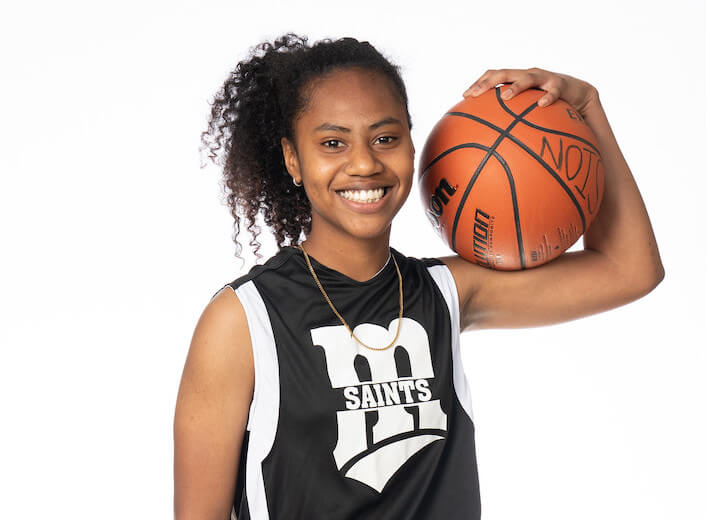 Girl holding basketball.