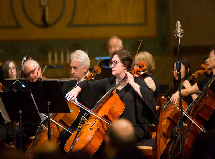 Joseph Ordaz conducting the Mission College symphony.