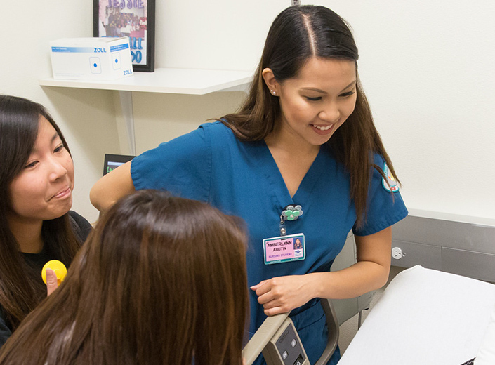 Student nurses working together in a simulated healthcare environment.