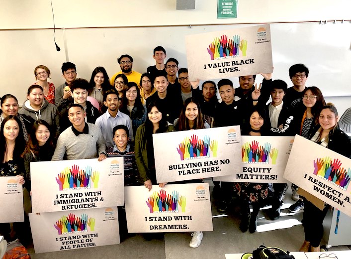 Group of students at an equity event holding signs like "I value Black Lives" etc.