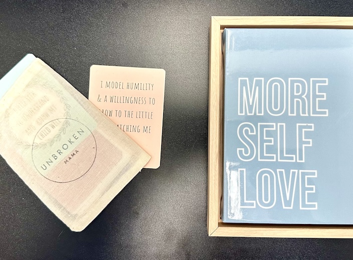 Sign in a frame reads "More Self Love". 