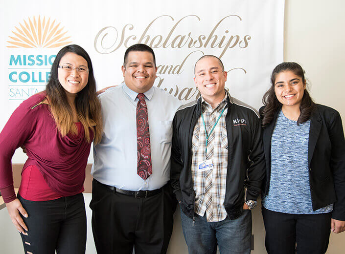 group of students in front of scholarships banner