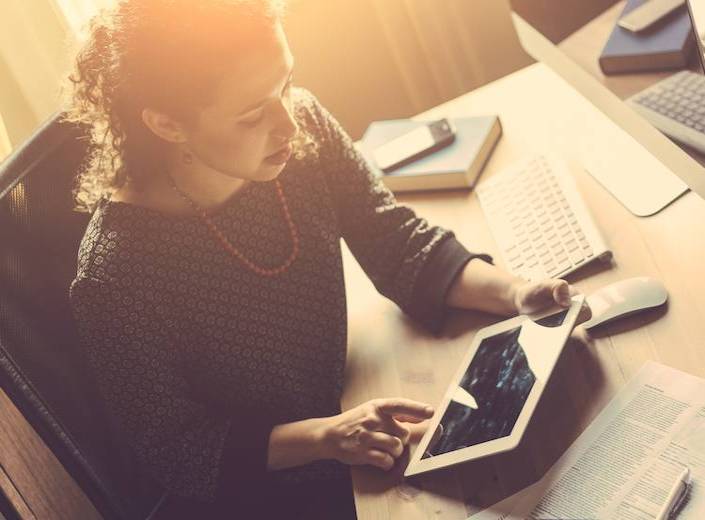 Girl with laptop at desk.