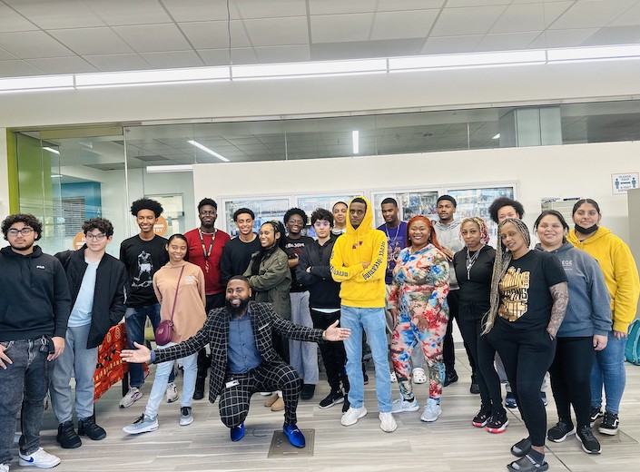 Umoja students and faculty pose in a group at a welcome event.