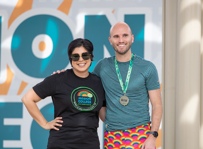 President Seher Awan poses with medal-winner of St. Paddy's 5k.